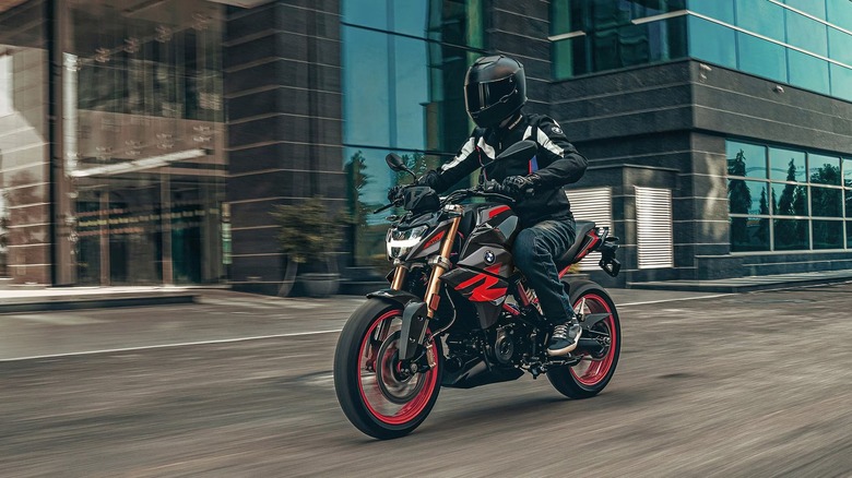 Man riding BMW G 310 R motorcycle on street