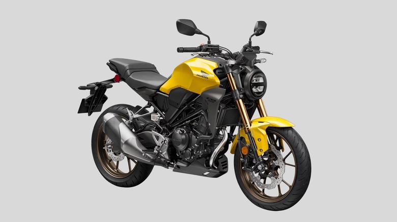 Yellow Honda CB300R motorcycle on gray background