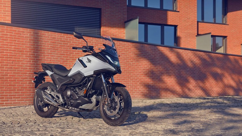 Honda NC750X DCT parked in front of red brick building