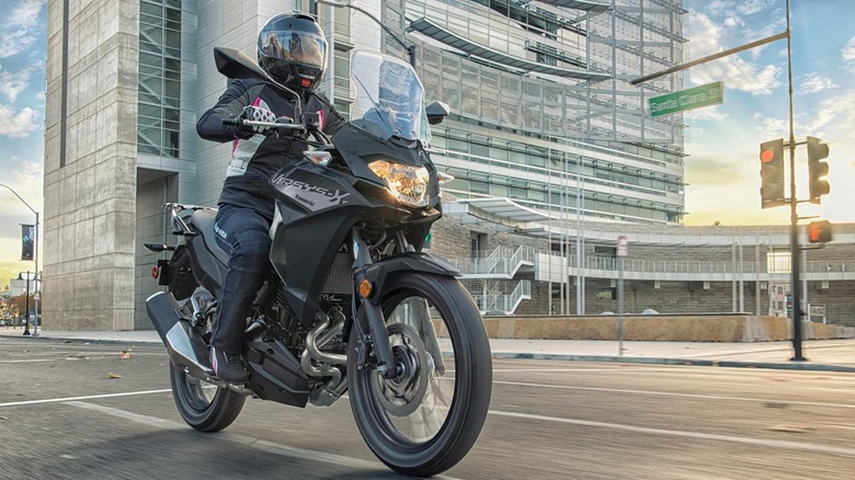 Woman riding Kawasaki Versys-X 300 on city road