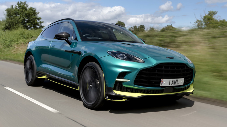 Aston Martin DBX 707 driving down a road