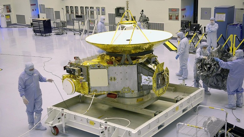 Workers removing protective cover on New Horizons