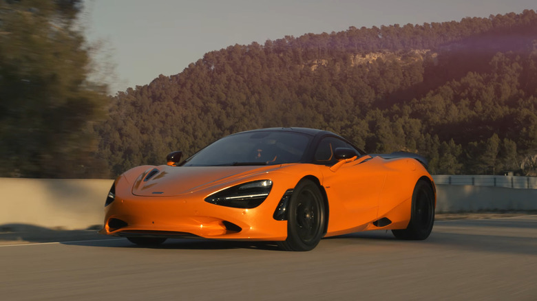 An orange 2025 McLaren 750S driving on track
