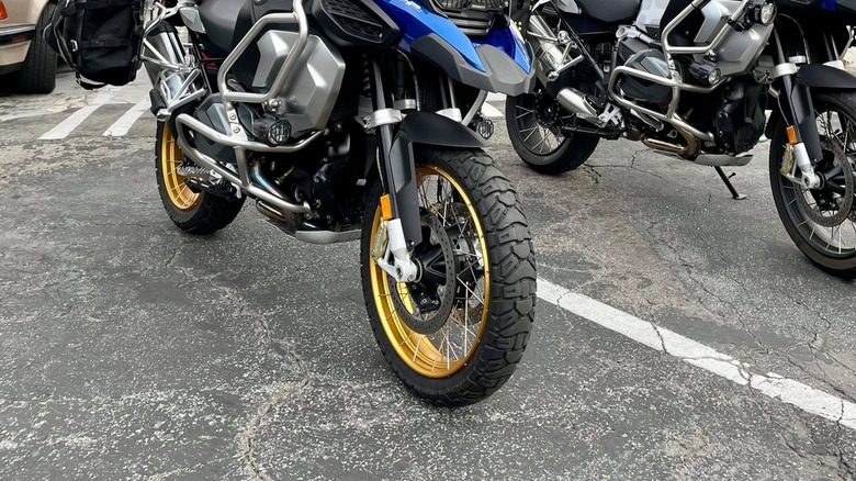 Two black and Gold BMW R120 GS bikes parked side by side outside