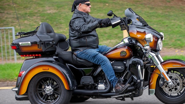 A customized Golden Harley Davidson Trike Tri Glide Ultra on the road