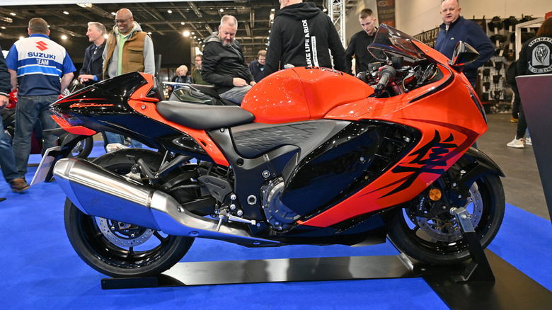 An orange and black hayabusa on display at an indoor motor show