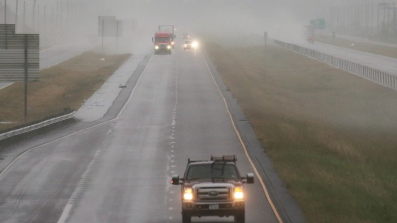 Trucks and car on I-10 Louisiana during rainfall