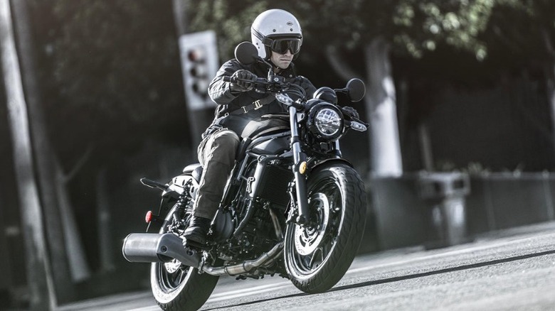 A man riding a black Kawasaki Eliminator