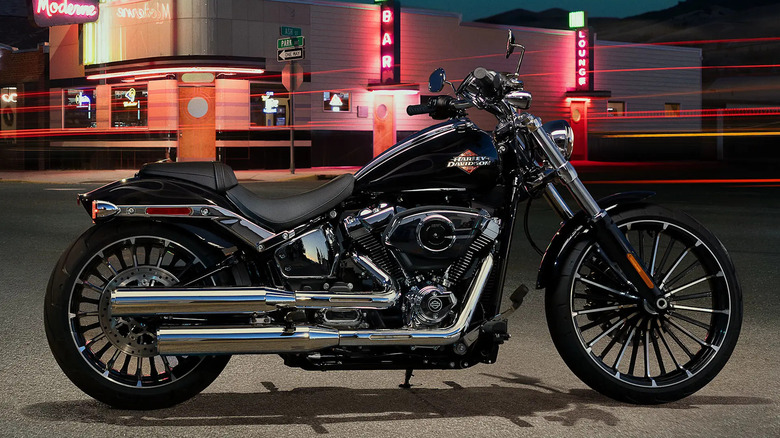 Black and silver 2025 Harley Breakout parked in an industrial setting somewhere at night, in a will illuminated area