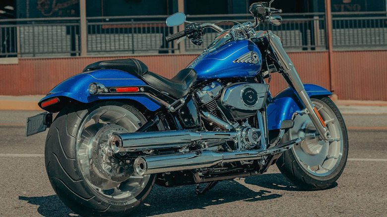 A Blue and Silver Harley Davidson Fat Boy for the 2025 Model year parked, with rear view prominent