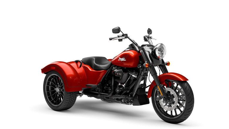 A whiskey fire red 205 Harley Davidson Trike Freewheeler against a white studio background
