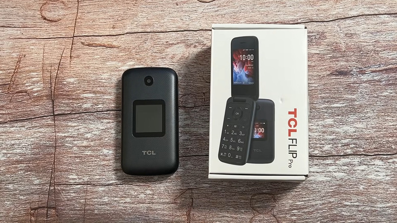 The TCL Flip Pro phone next to its box on a table