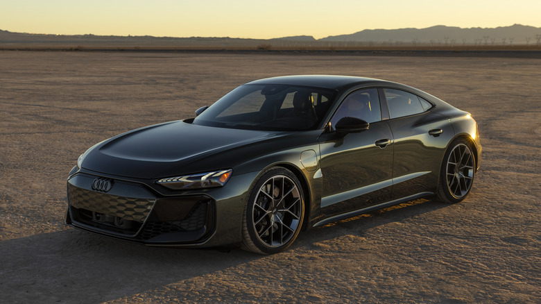 Dark green Audi RS e-tron GT performance parked in a desert at sunset