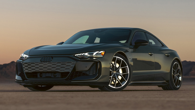 Dark green Audi RS e-tron GT performance parked in a desert at sunset