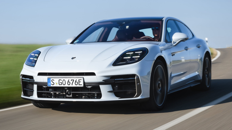 White Porsche Panamera S Turbo E-Hybrid driving on a rural road