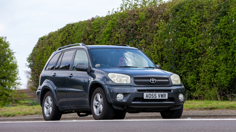 A dark blue 2005 Toyota RAV4 driving