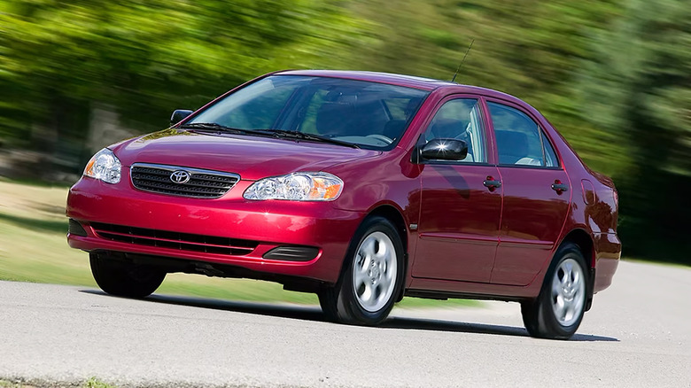 A red 2002 Toyota Corolla driving