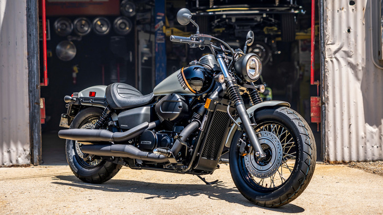 A 2024 Honda Shadow Phantom parked in front of a garage