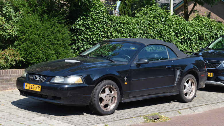 A black 2002 Ford Mustang Convertible parked on a street