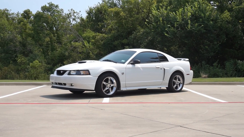 A white 2004 Ford Mustang GT parked