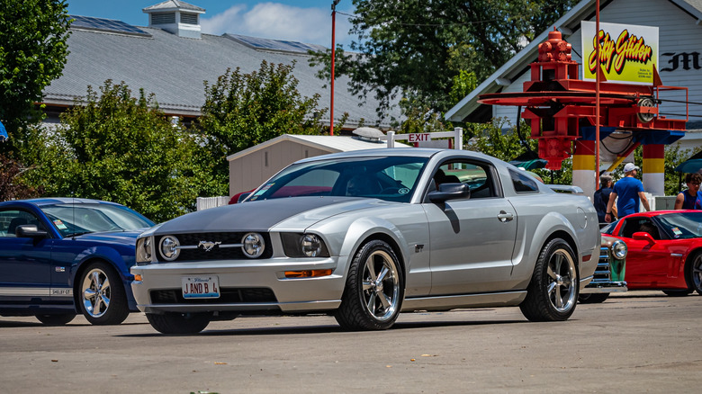 A silver 2008 Ford Mustang driving through town