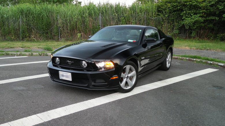 A black 2013 Ford Mustang parked