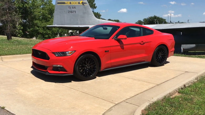 A red 2015 Ford Mustang GT parked