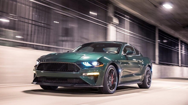 A green 2019 Ford Mustang Bullitt driving in a tunnel