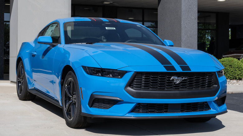 A light blue 2025 Ford Mustang parked