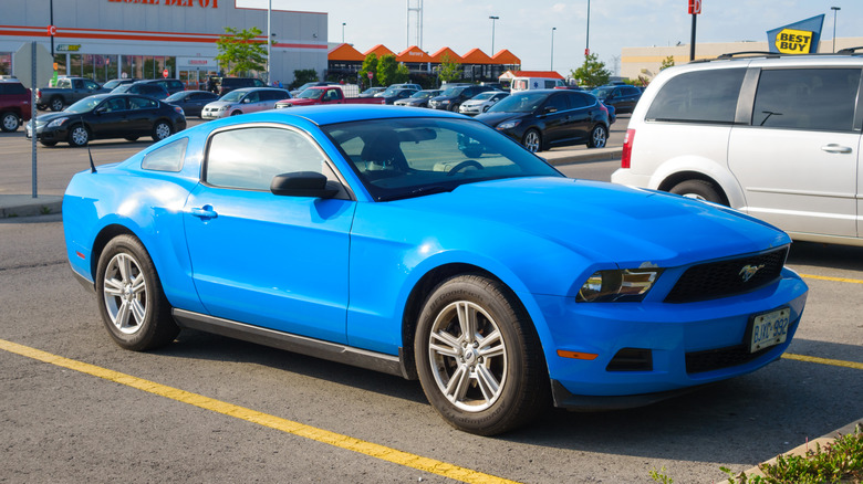A light blue 2010 Ford Mustang parked in a parking lot