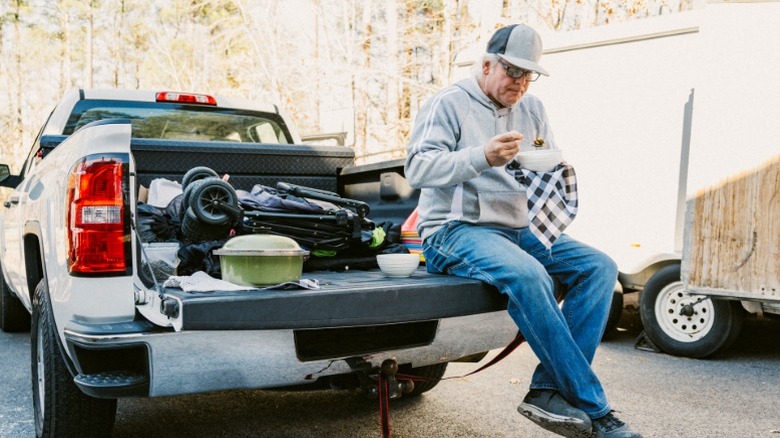a construction guy sitting on a pickup truck