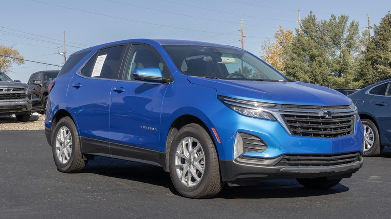 A blue 2024 Chevrolet Equinox parked at a dealership