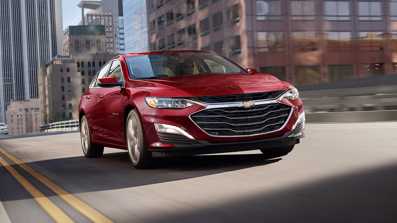 A red 2025 Chevrolet Malibu driving