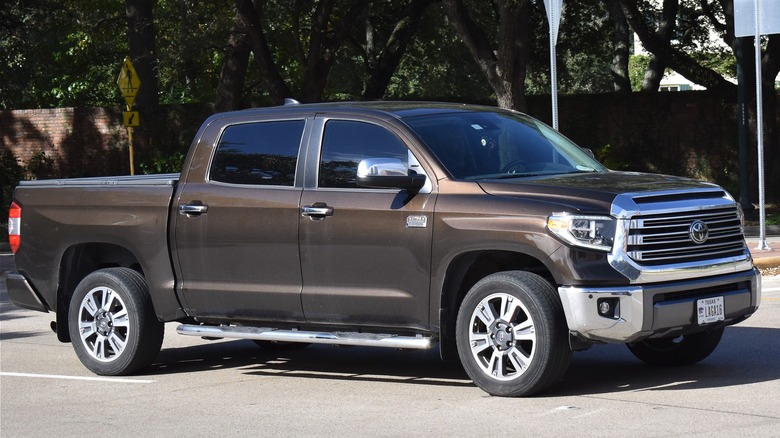 A dark brown Toyota Tundra parked roadside with a bold, commanding presence.