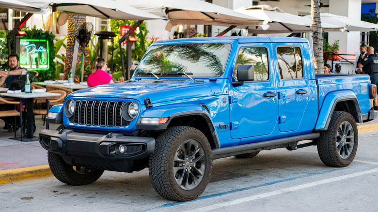 blue jeep gladiator sport parked on street