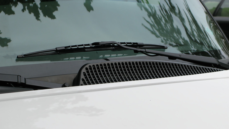 Windshield wiper arm mounted on a car