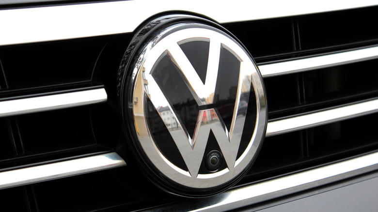 A chromed Volkswagen badge on the grill of an unidentified model