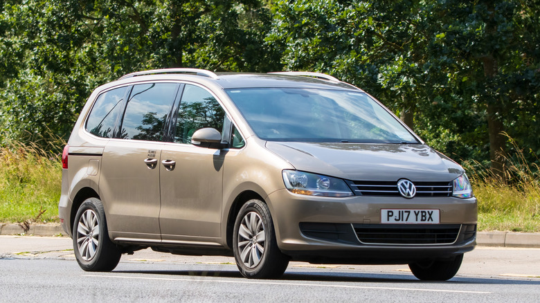A VW Sharan Minivan seen here in a side-on view in a parking lot, right two-quarters view visible