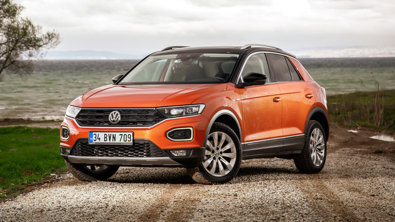 A reddish orange Subcompact Volkswagen T-Roc Crossover pictured here parked atop a hill