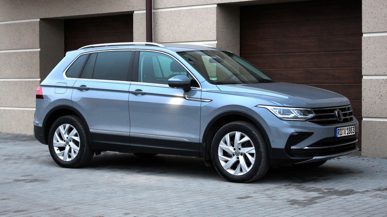 A steely Volkswagen Tiguan parked in front of garage entrances in Ukraine