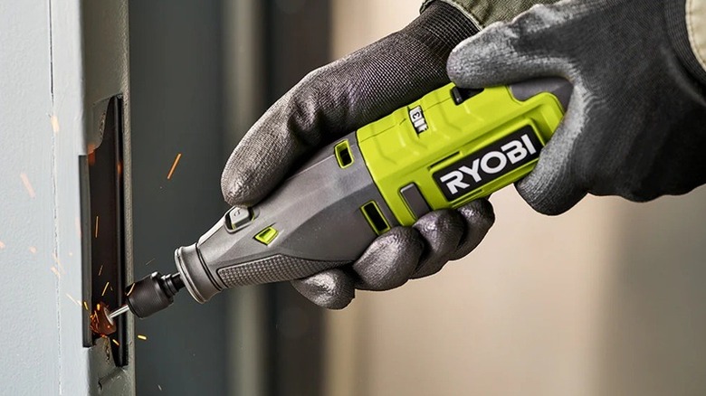 Person using Ryobi cordless rotary tool