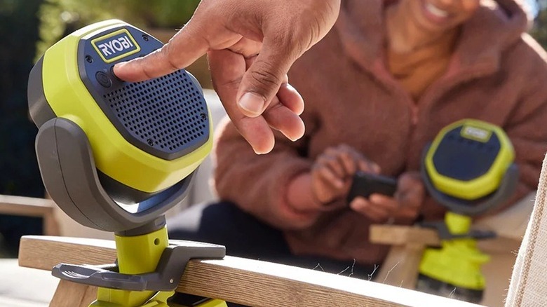 Person using Ryobi Verse Clamp Speaker