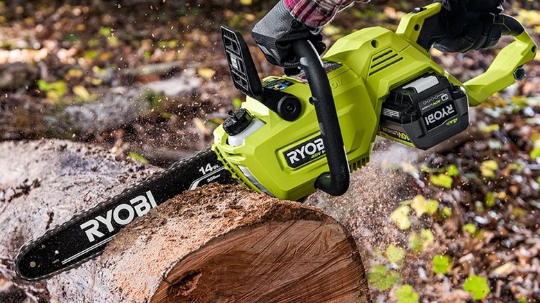 Person cutting log with Ryobi chainsaw