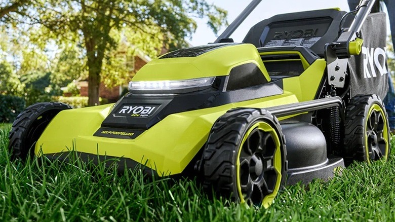 Person using Ryobi self-powered mower