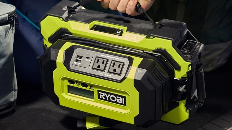 Person holding Ryobi 1,000W power source