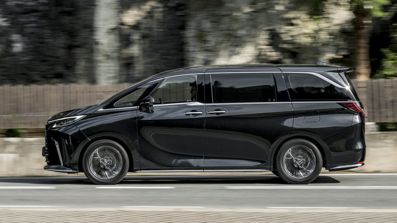 Lexus LM driving down a road