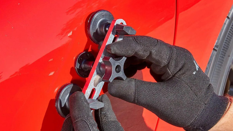 Man using Pittsburgh Crossbar Dent Repair Kit