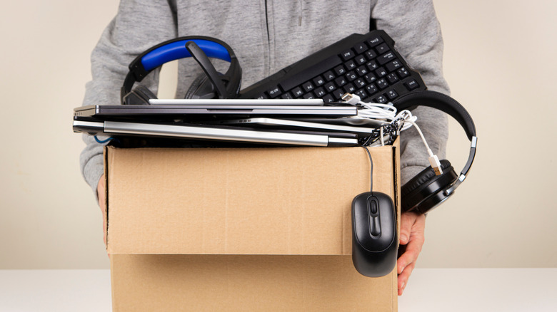 Person holding box old electronics