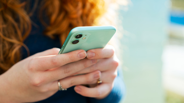 Woman holding green iphone
