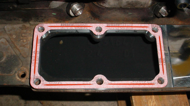 A close-up view of an open grid heater delete plate with a gasket around the outside.